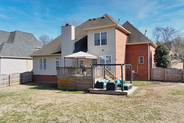 back of house with a fenced backyard, an outdoor hangout area, crawl space, a lawn, and a wooden deck