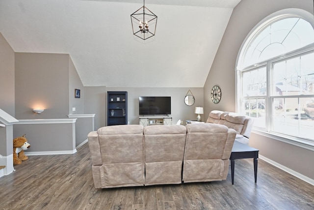 living area featuring built in shelves, an inviting chandelier, vaulted ceiling, wood finished floors, and baseboards