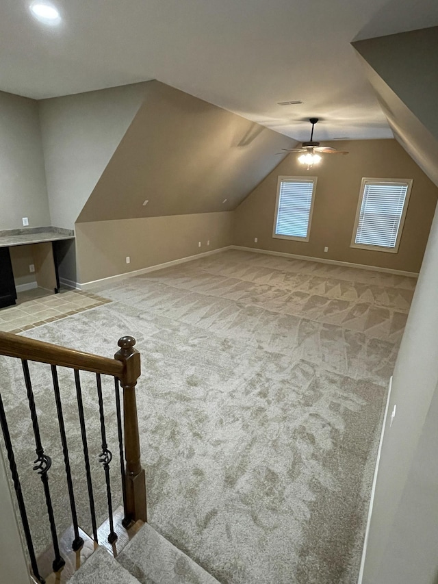 bonus room with visible vents, a ceiling fan, vaulted ceiling, baseboards, and carpet