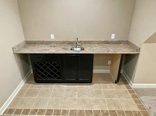 interior space with baseboards, vanity, and tile patterned floors