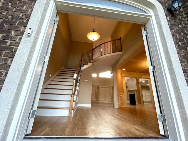 interior space with high vaulted ceiling and wood finished floors