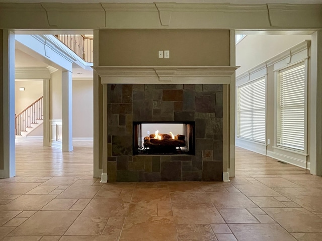 room details with a multi sided fireplace and crown molding