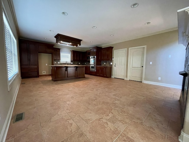 kitchen with baseboards, stainless steel double oven, visible vents, and a healthy amount of sunlight