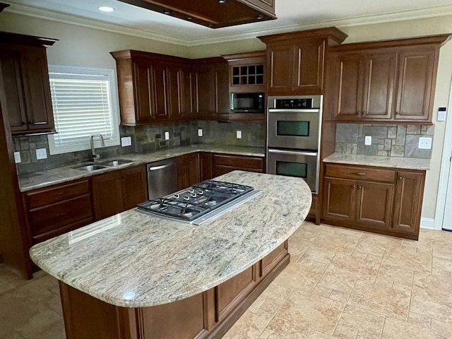 kitchen featuring a sink, appliances with stainless steel finishes, a center island, tasteful backsplash, and crown molding