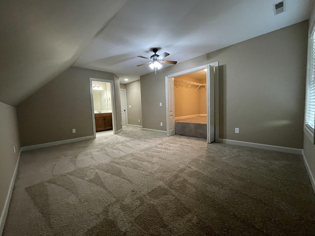 bonus room featuring lofted ceiling, light carpet, a ceiling fan, visible vents, and baseboards