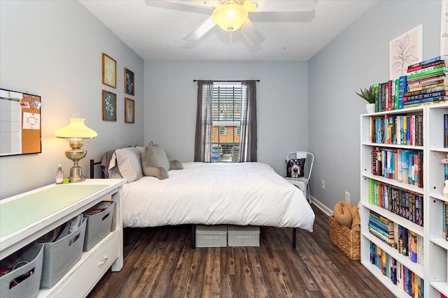 bedroom with ceiling fan, baseboards, and dark wood finished floors