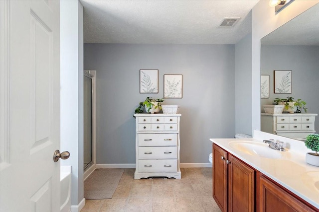 full bath featuring double vanity, a stall shower, visible vents, a textured ceiling, and a sink