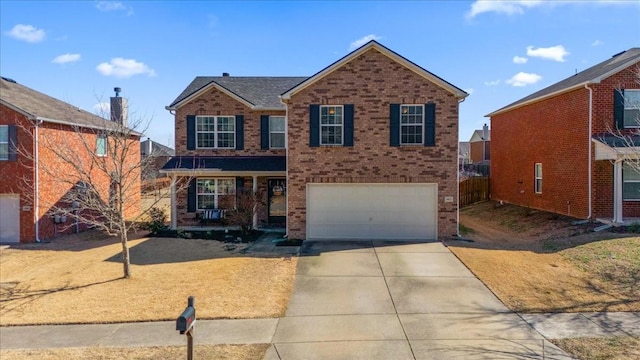 traditional-style home featuring a garage, a front lawn, concrete driveway, and brick siding