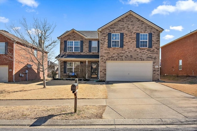 traditional home with driveway, brick siding, and an attached garage