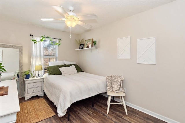 bedroom with a ceiling fan, baseboards, and wood finished floors