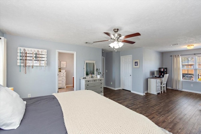 bedroom with dark wood-style flooring, visible vents, a ceiling fan, a textured ceiling, and baseboards