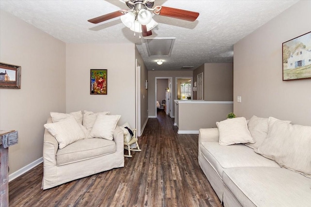 living room with a textured ceiling, wood finished floors, a ceiling fan, and baseboards