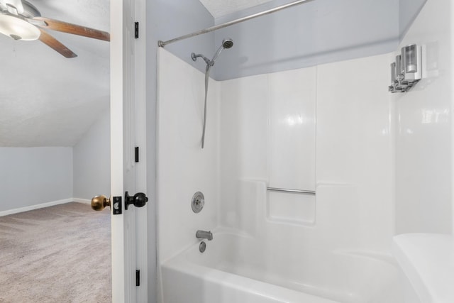 bathroom featuring ceiling fan, a textured ceiling, bathtub / shower combination, baseboards, and vaulted ceiling