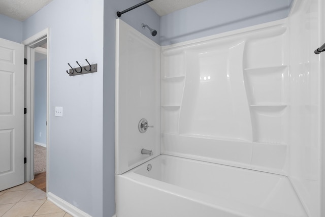 full bath featuring a textured ceiling, baseboards, and tile patterned floors