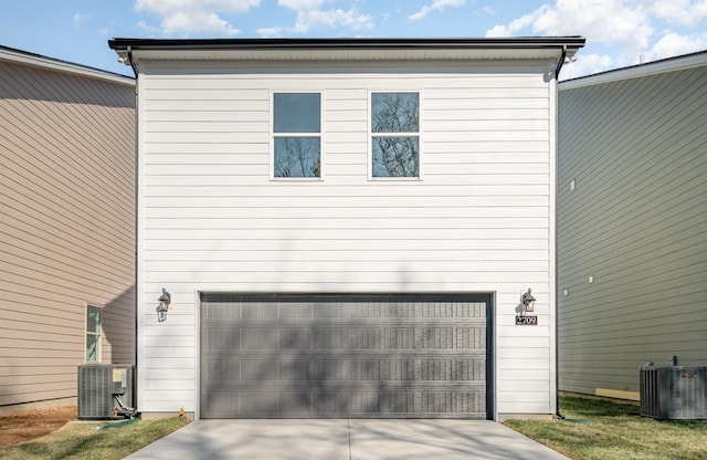 exterior space with concrete driveway and central AC unit