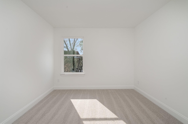 empty room with light carpet and baseboards