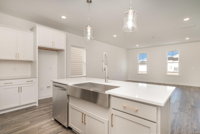 kitchen featuring visible vents, light countertops, stainless steel dishwasher, decorative backsplash, and dark wood-style floors