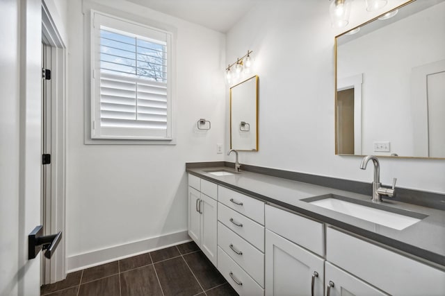 full bathroom featuring tile patterned floors, a sink, baseboards, and double vanity