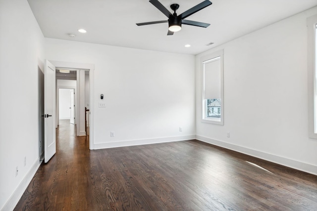 empty room featuring ceiling fan, baseboards, dark wood-type flooring, and recessed lighting