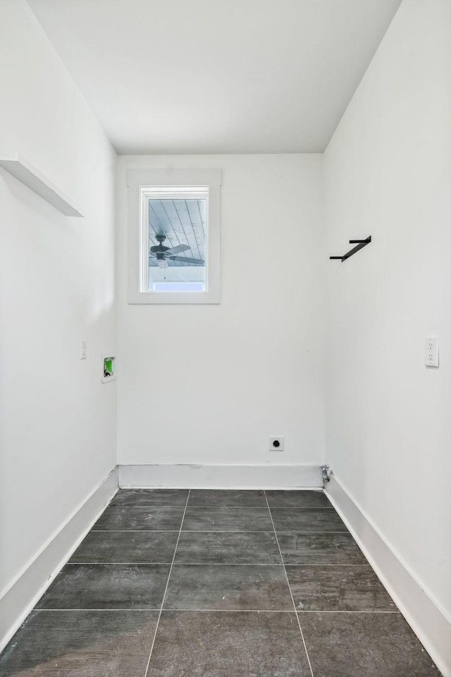 laundry area featuring laundry area, baseboards, and electric dryer hookup