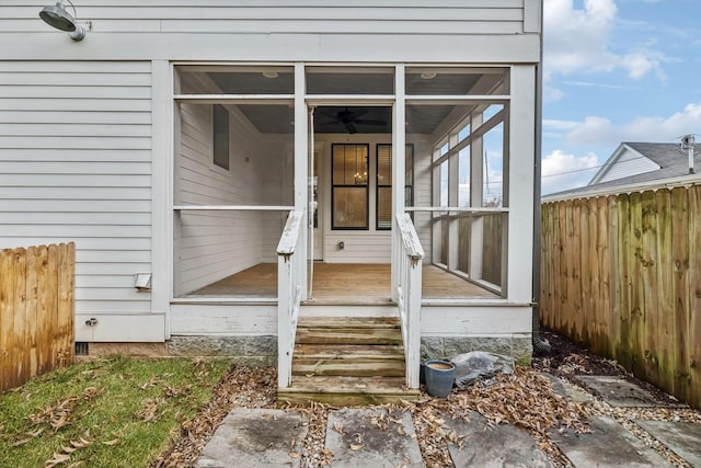 view of exterior entry with fence