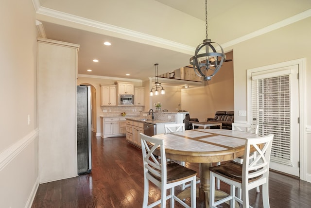 dining area with ornamental molding, dark wood finished floors, arched walkways, and a chandelier