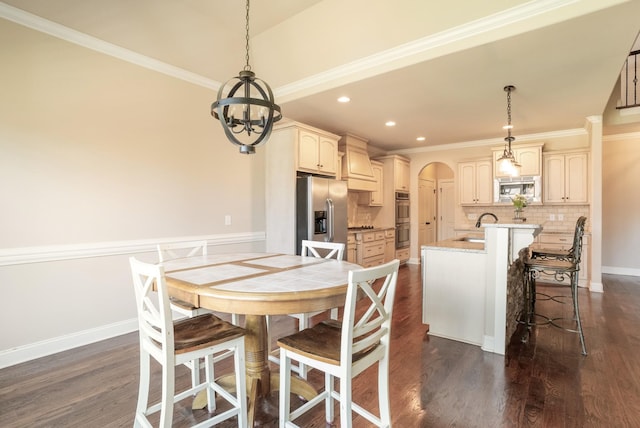 dining space with arched walkways, dark wood-type flooring, and crown molding