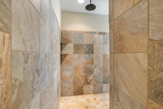 interior details featuring tiled shower