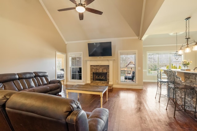 living room featuring baseboards, ceiling fan, wood finished floors, a fireplace, and high vaulted ceiling