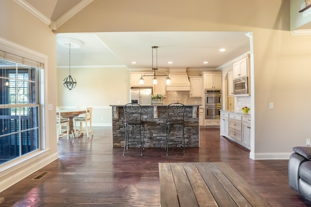 kitchen with stainless steel appliances, dark wood-style flooring, ornamental molding, decorative backsplash, and custom range hood