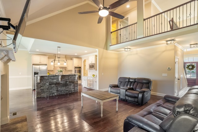 living room with ornamental molding, dark wood finished floors, visible vents, and baseboards