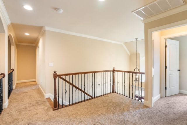 hall featuring carpet, visible vents, and crown molding