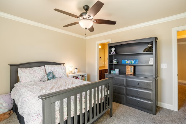 carpeted bedroom with ceiling fan, connected bathroom, baseboards, and crown molding