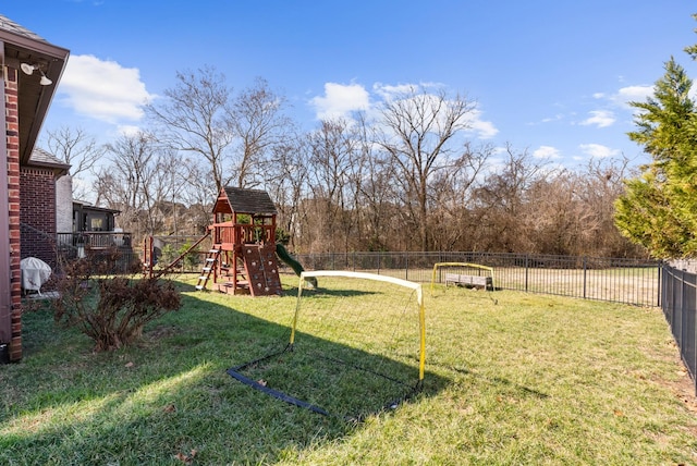 view of yard featuring fence and a playground