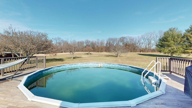 outdoor pool with a deck and a yard