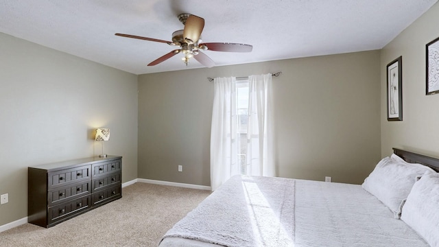 bedroom with ceiling fan, baseboards, and carpet flooring