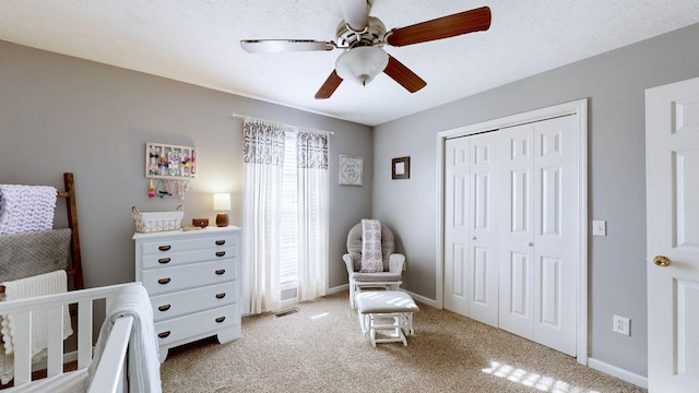 bedroom with baseboards, a closet, visible vents, and light colored carpet