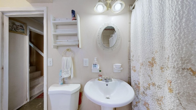 bathroom with toilet and a sink