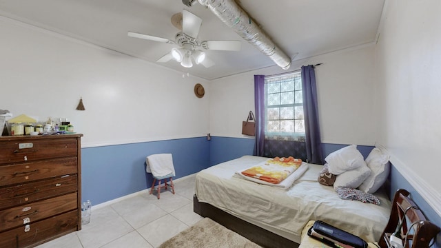 bedroom with tile patterned flooring, ceiling fan, and baseboards