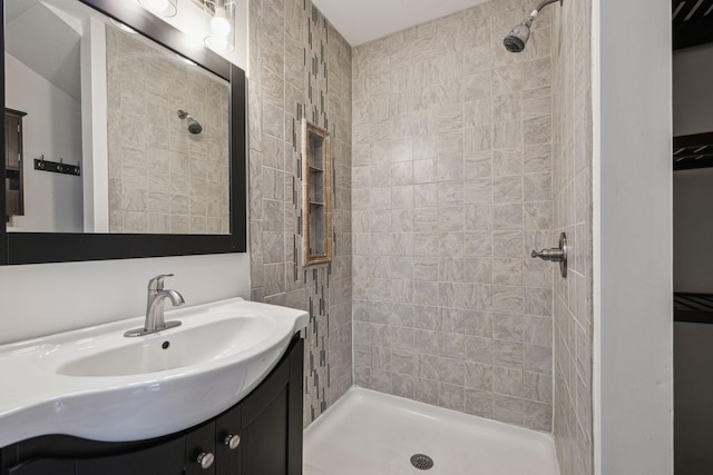 bathroom featuring a shower stall and vanity