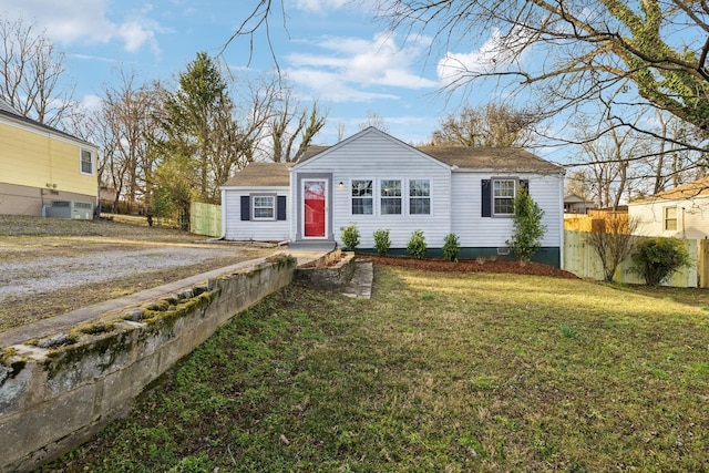 view of front of property with fence and a front lawn