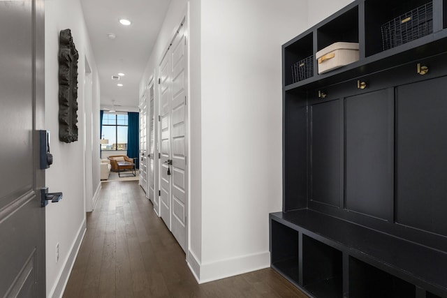 mudroom with baseboards, dark wood-style flooring, and recessed lighting