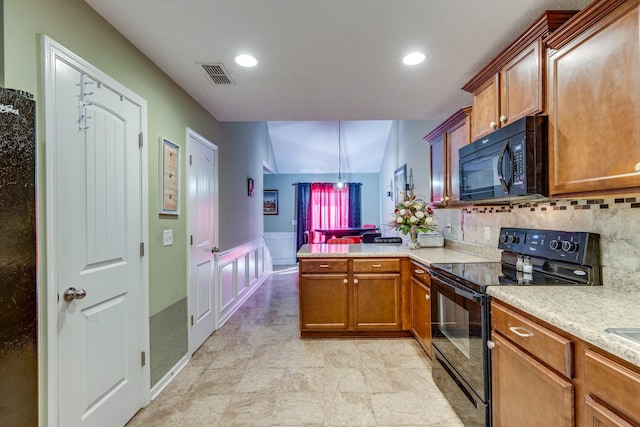 kitchen with a peninsula, visible vents, light countertops, black appliances, and brown cabinetry