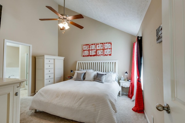 bedroom featuring a ceiling fan, light carpet, connected bathroom, vaulted ceiling, and a textured ceiling