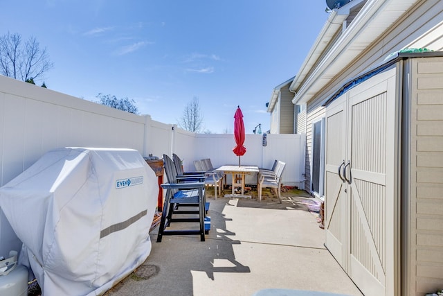 view of patio / terrace featuring a fenced backyard, area for grilling, and outdoor dining space