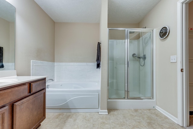 bathroom featuring a textured ceiling, a shower stall, vanity, tile patterned flooring, and a bath