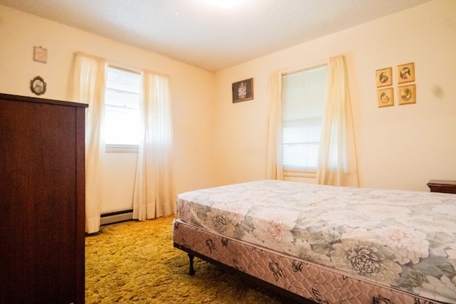 bedroom with carpet floors and a baseboard radiator