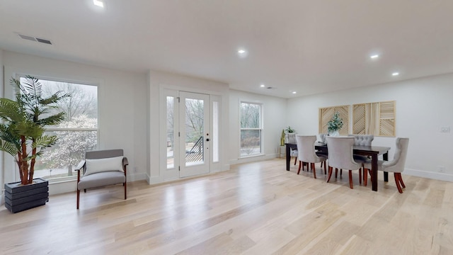 dining room with a wealth of natural light, light wood-type flooring, visible vents, and recessed lighting