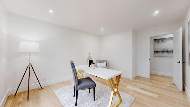 office space with light wood finished floors, recessed lighting, and baseboards