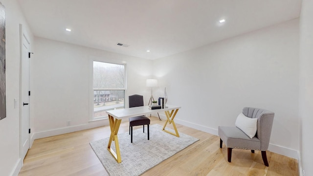 office space featuring recessed lighting, light wood-type flooring, visible vents, and baseboards